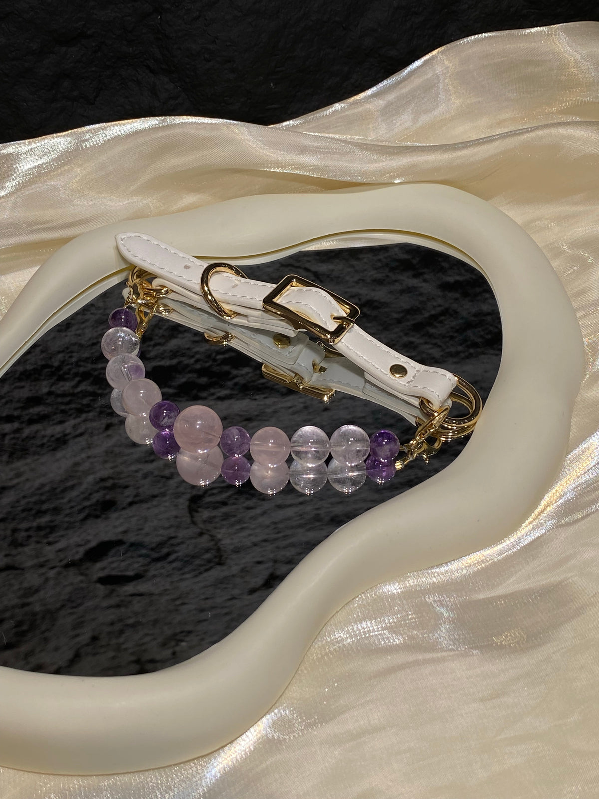 Lavender Blush crystal pet collar with pink, purple and clear beads styled on cream satin