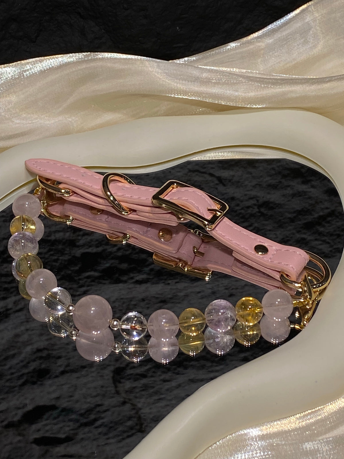 Peach Glow crystal pet collar with blush pink, warm yellow and clear beads styled on cream satin
