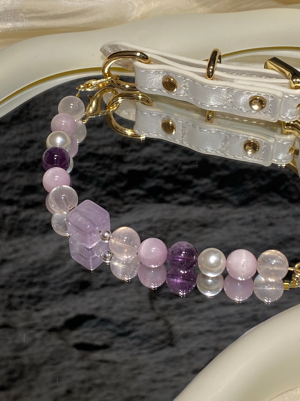 Taro Purple crystal pet collar with lavender beads and white strap styled on cream satin