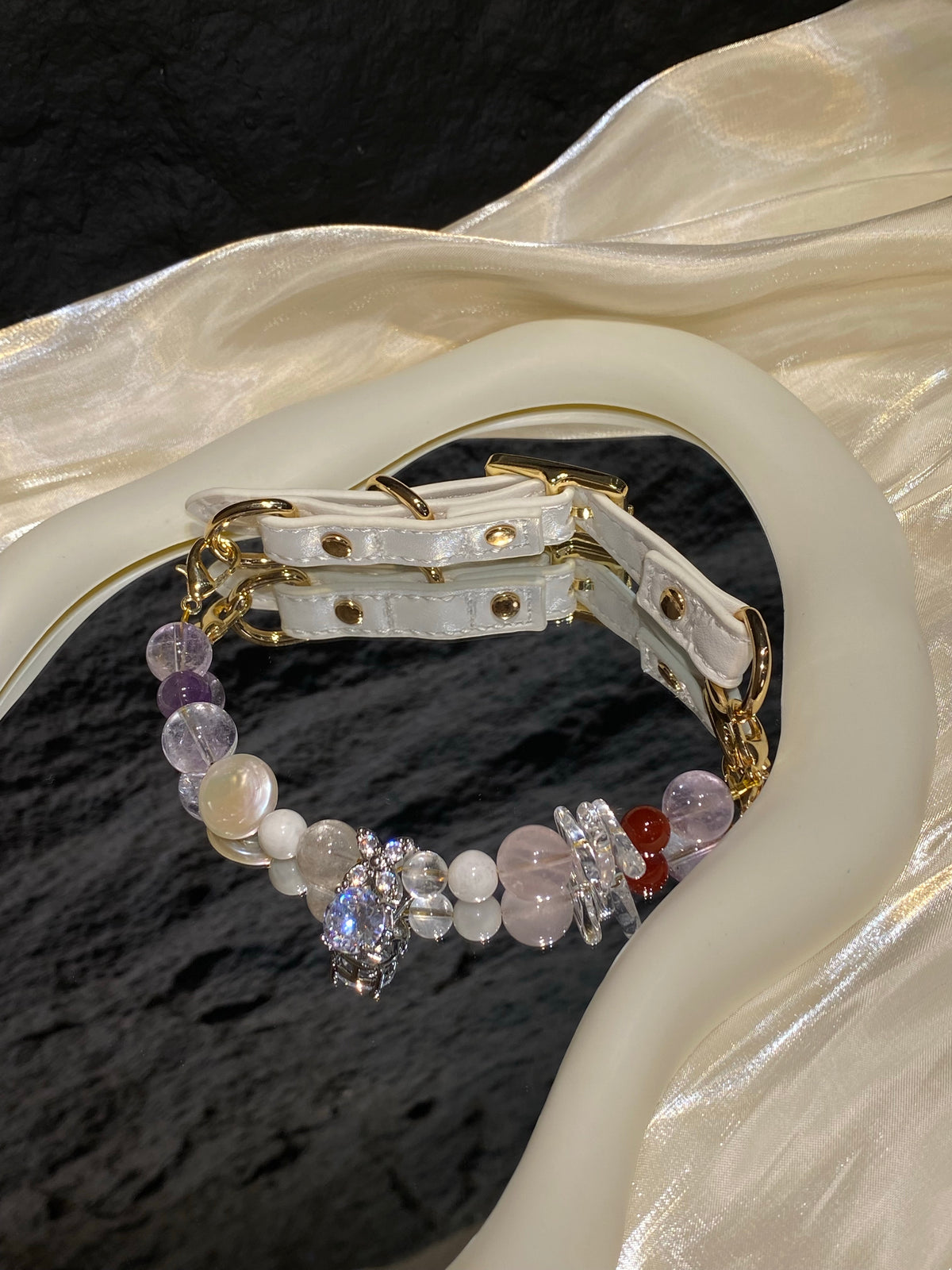 Lavender Charm crystal pet collar with mixed pastel beads and sparkling charm styled on cream satin