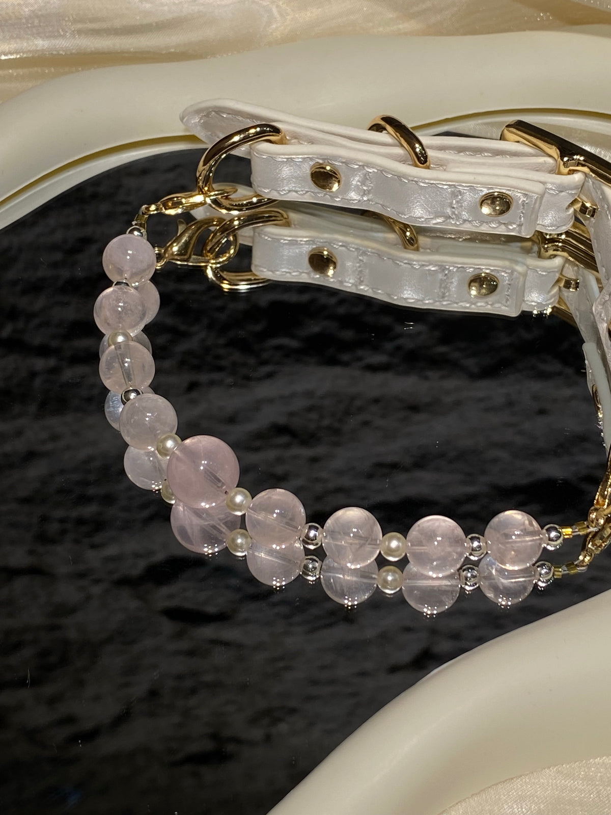 Peach Blush crystal pet collar with pale pink beads and white strap styled on cream satin