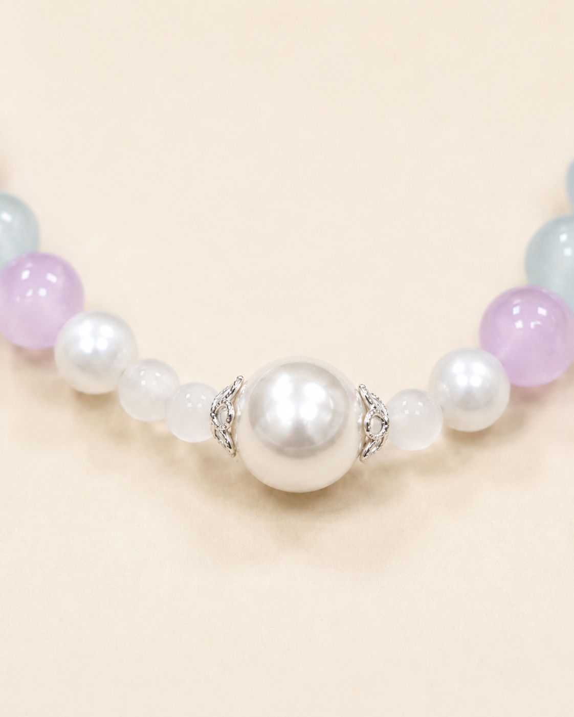 Close-up of pearl-style centerpiece on pastel pet necklace
