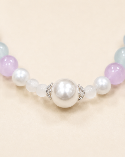 Close-up of pearl-style centerpiece on pastel pet necklace