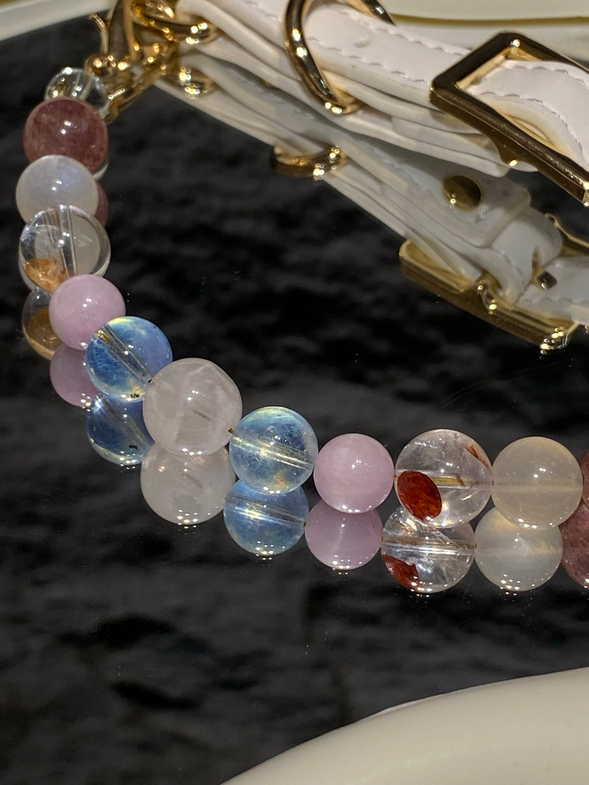 Close-up of pastel pink, blue and clear beads on the Macaron pet collar