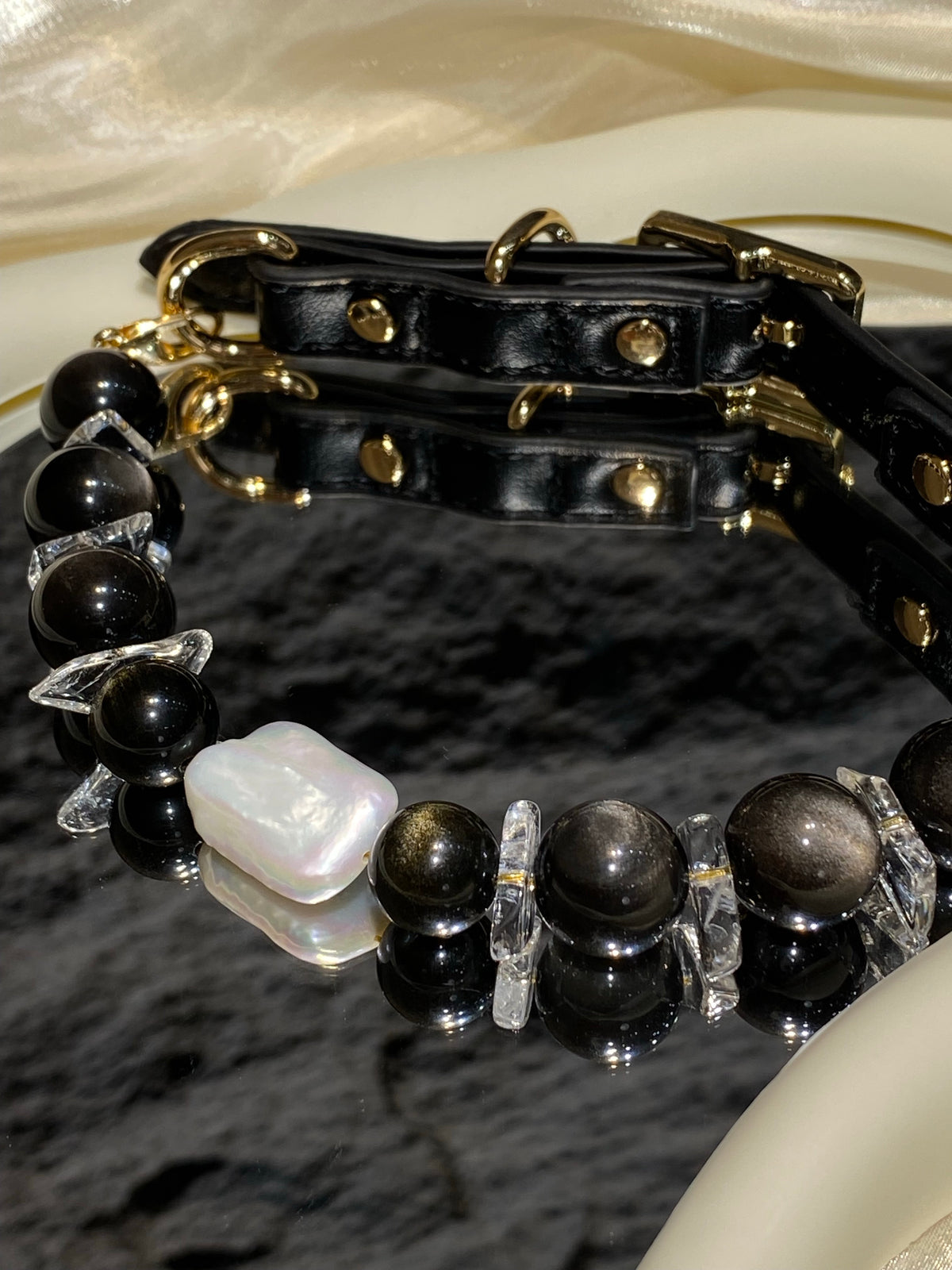 Close-up of dark beads and baroque pearl centerpiece on the Midnight Baroque pet collar