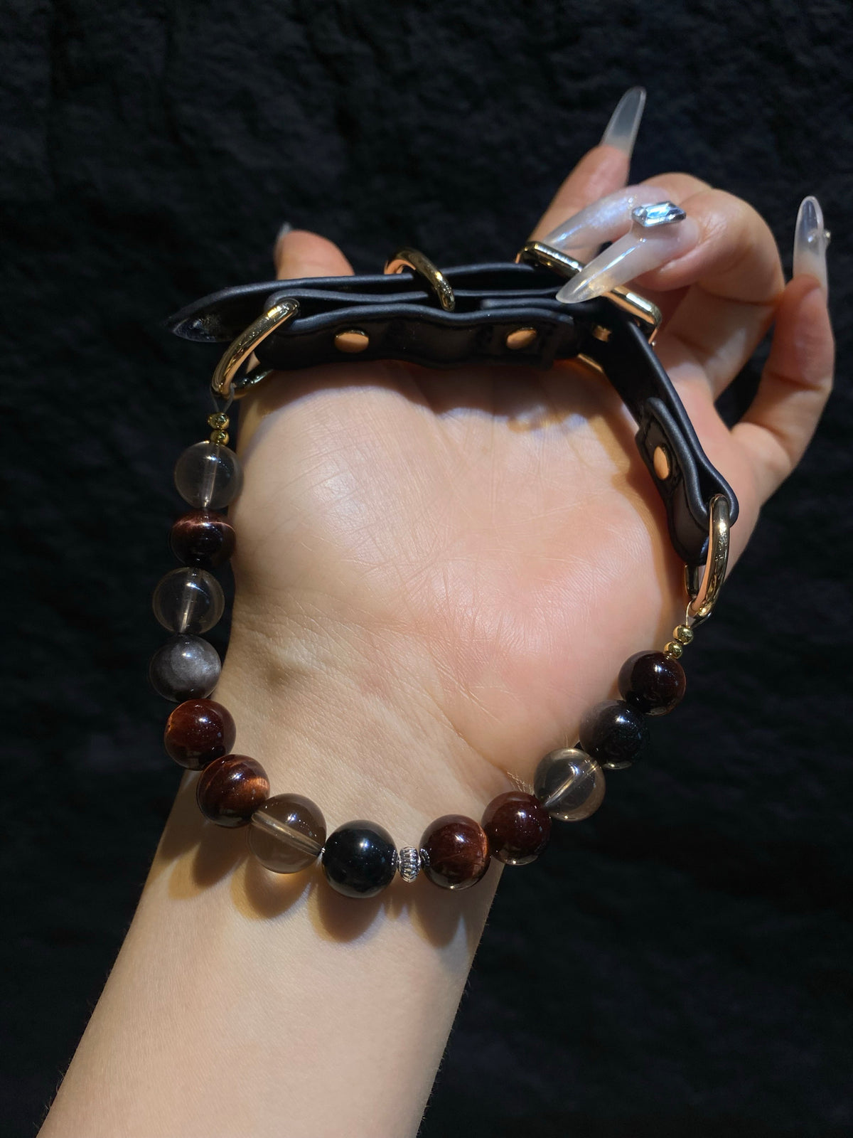 Black strap and gold-tone hardware construction detail on Smoky Ember crystal pet collar
