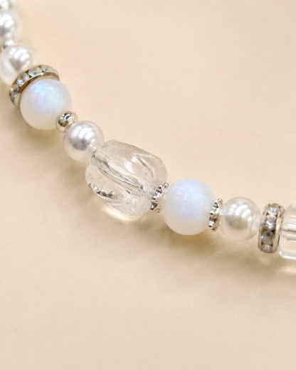 Close-up of pearl-style, iridescent and clear faceted beads on the Ivory Glow pet necklace