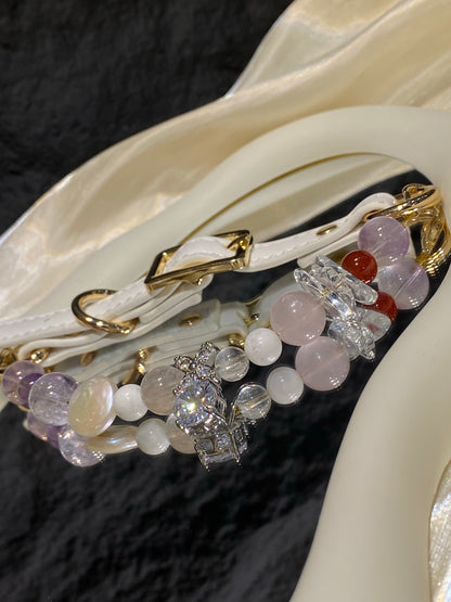 Close-up of pale pink, red and clear decorative accents on Lavender Charm crystal pet collar