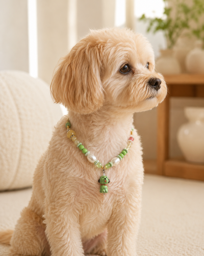 Side portrait of small dog wearing green puppy-charm pet necklace