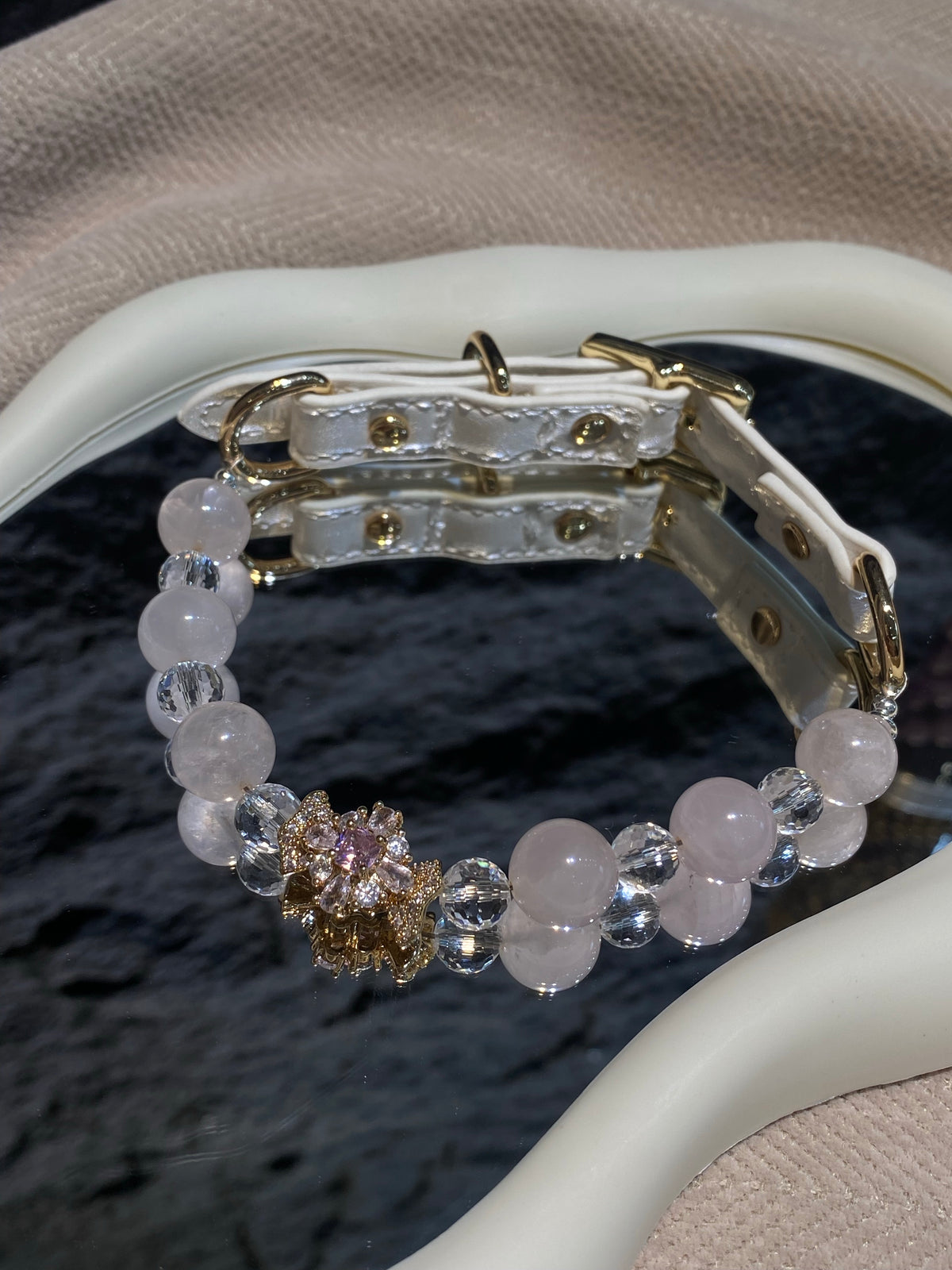 Close-up of pink beads, clear faceted spacers and bow centerpiece on the Blush Bow pet collar