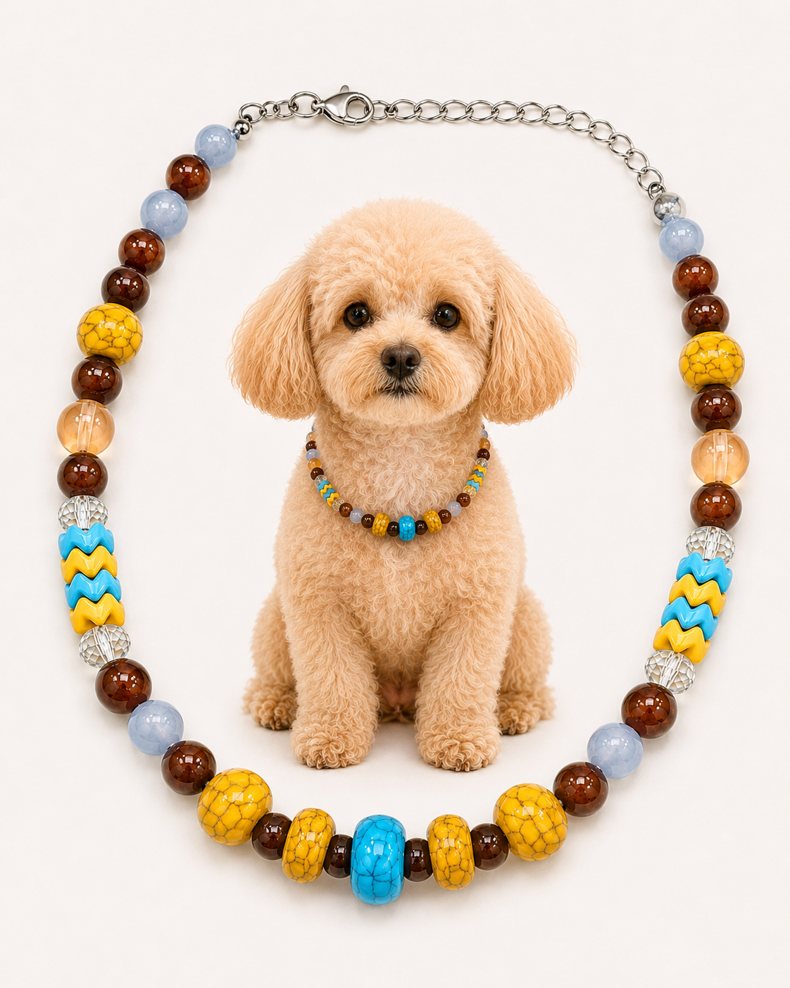 A colorful beaded dog collar necklace displayed around a small fluffy tan dog on a plain light background. The necklace features brown, yellow, light blue, and turquoise beads with silver-toned chain links and rhinestone accents.