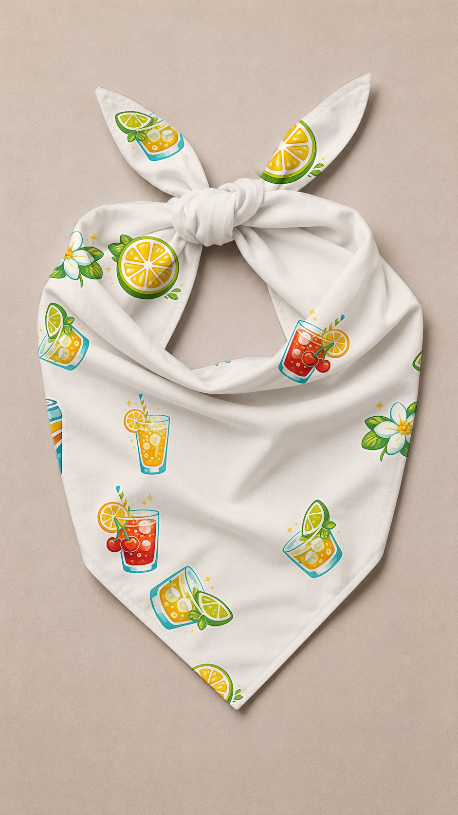 A white triangular bandana or pet bandana with a knotted top, featuring a colorful print of cocktail glasses, limes, and citrus slices, displayed flat on a neutral beige background.
