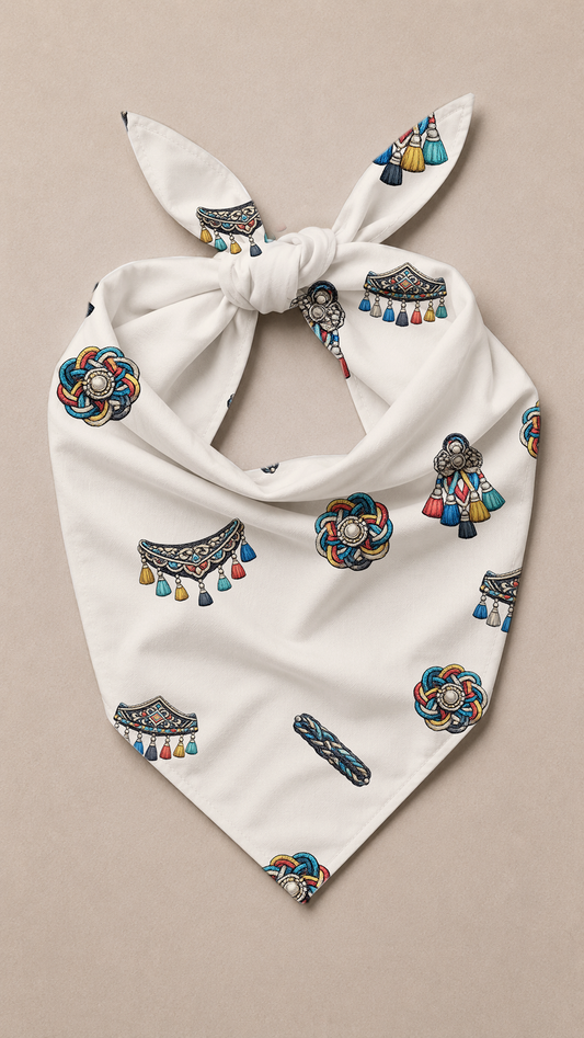 A white tie-front bandana scarf featuring a colorful bohemian pattern of tassel lamps, decorated and draped on a neutral beige background.