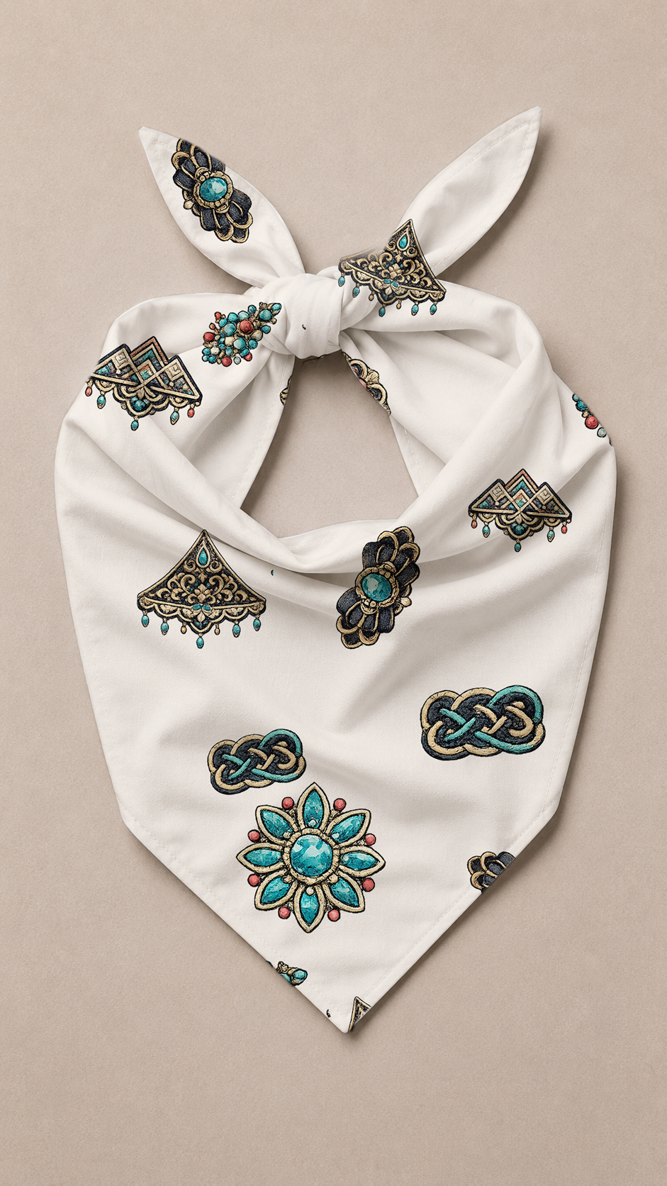 A white fabric bandana tie-neck scarf featuring a repeating pattern of turquoise, black, and red geometric and floral motifs, laid flat on a neutral beige background.