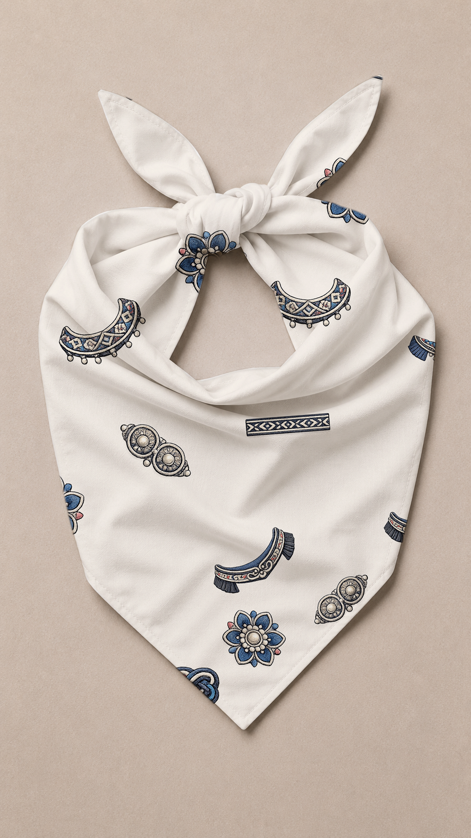 An off-white cotton bandana tie-on with a blue and gray paisley pattern, displayed flat on a neutral beige background.
