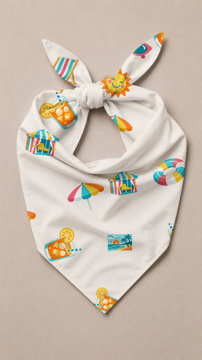 A white bandana-style pet collar with tie-ends, featuring a colorful summer-themed print of beach umbrellas, lounge chairs, palm trees, and a smiling sun, displayed flat on a neutral beige background.