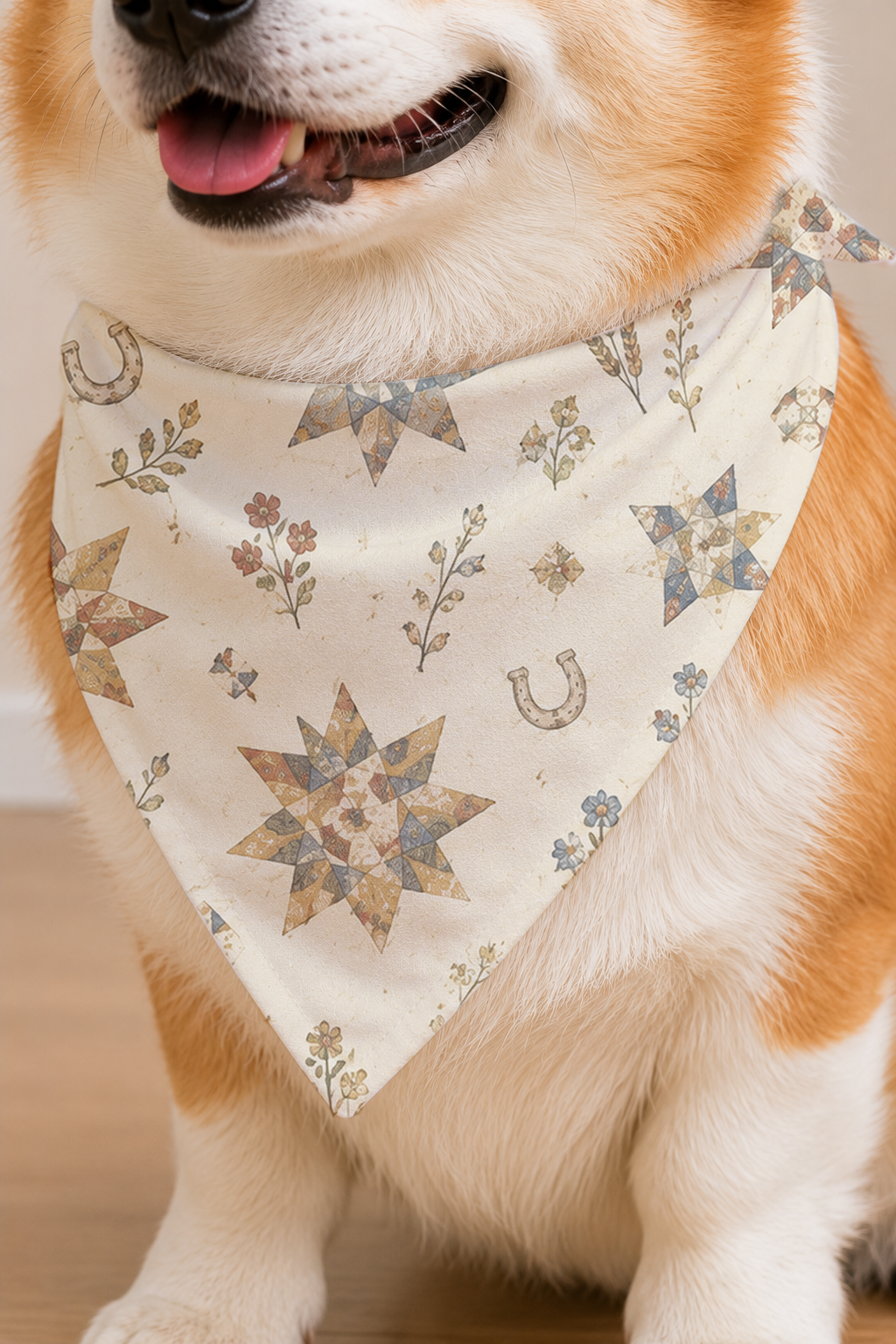 A close-up of a dog wearing a cream-colored bandana with a western-style print of stars, horseshoes, and floral motifs.