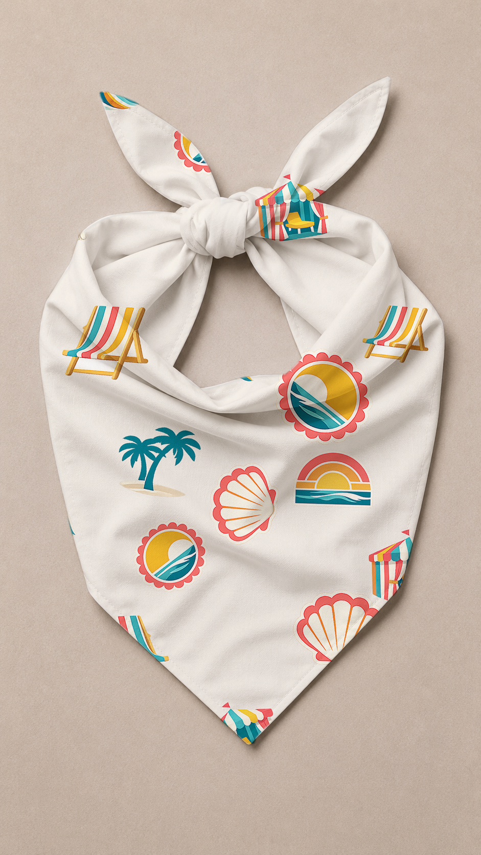 A white dog bandana with a knotted top, featuring a colorful beach-themed print of palm trees, beach chairs, seashells, and sunsets, laid flat on a neutral beige background.